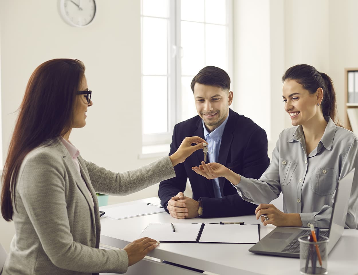 Agent handing keys to couple